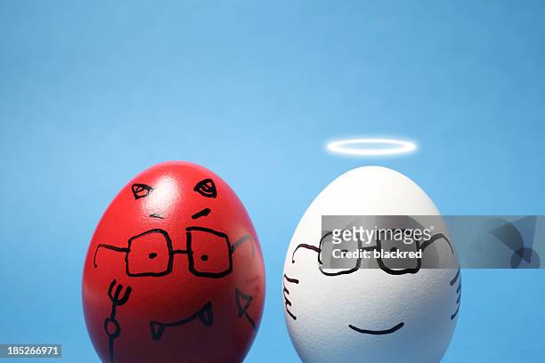 evil and angel eggs - devil stock pictures, royalty-free photos & images