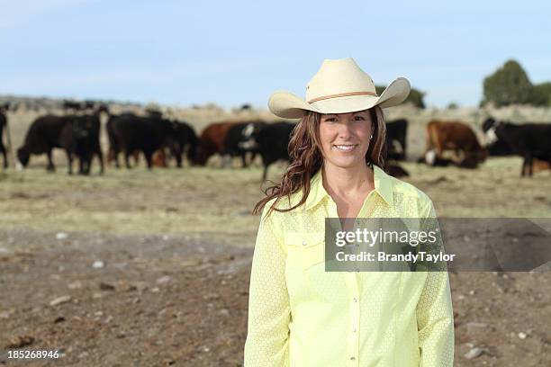 beautiful young woman on her cattle ranch - rodeo background stock pictures, royalty-free photos & images