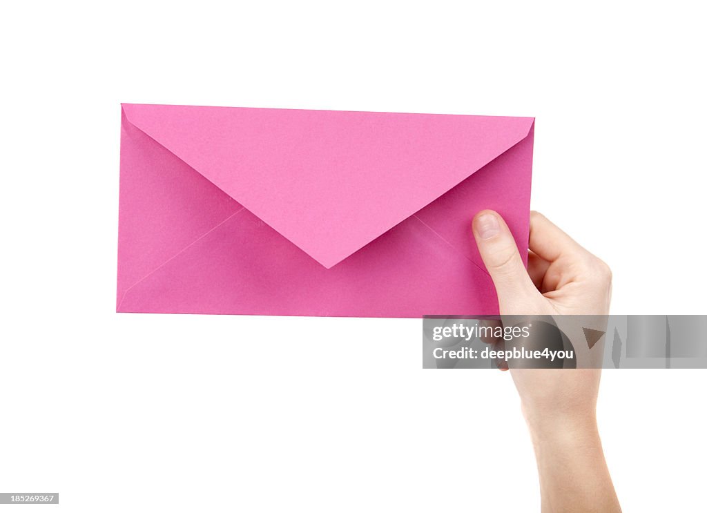 Pink letter in female hand on white