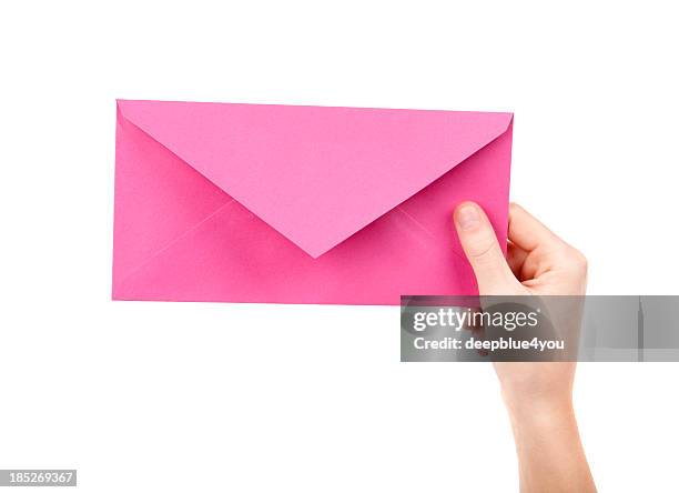 pink letter in female hand on white - person holding blank piece of paper stock pictures, royalty-free photos & images