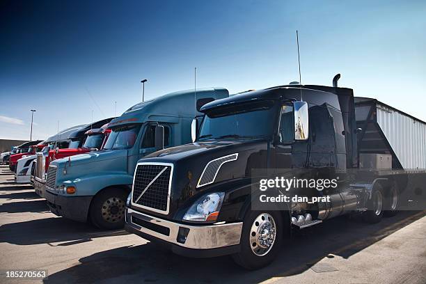 semi trucks in a row - convoy stockfoto's en -beelden