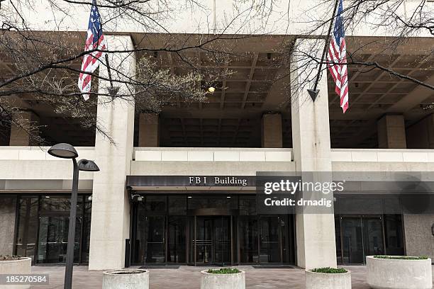 fbi building entrance flanked by flags - fbi flag stock pictures, royalty-free photos & images