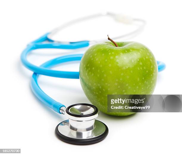 stethoscope and green apple - stethoscope white background stock pictures, royalty-free photos & images
