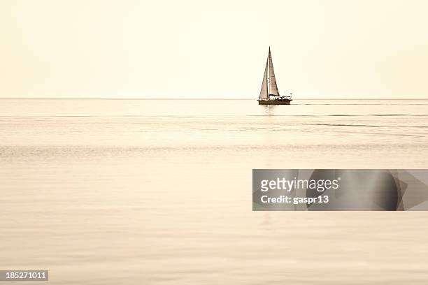 single sailboat on horizon - sailboat in distance stock pictures, royalty-free photos & images