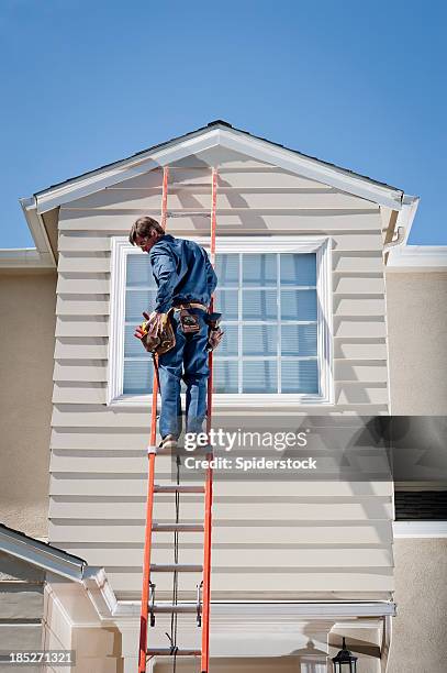 handyman in uniform on ladder - roof inspector stock pictures, royalty-free photos & images