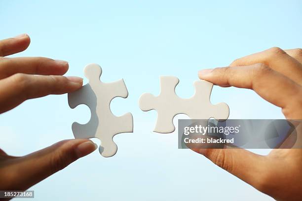 piecing together puzzle - holding above head stock pictures, royalty-free photos & images