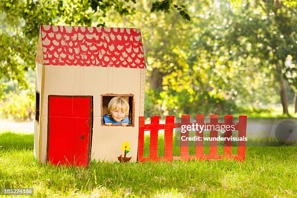 boy playing in a playhouse - playhouse stockfoto's en -beelden