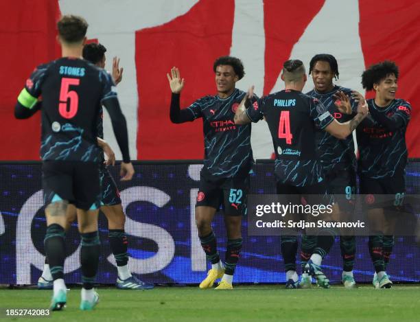 Micah Hamilton of Manchester City celebrates with teammates after scoring their team's first goal during the UEFA Champions League match between FK...