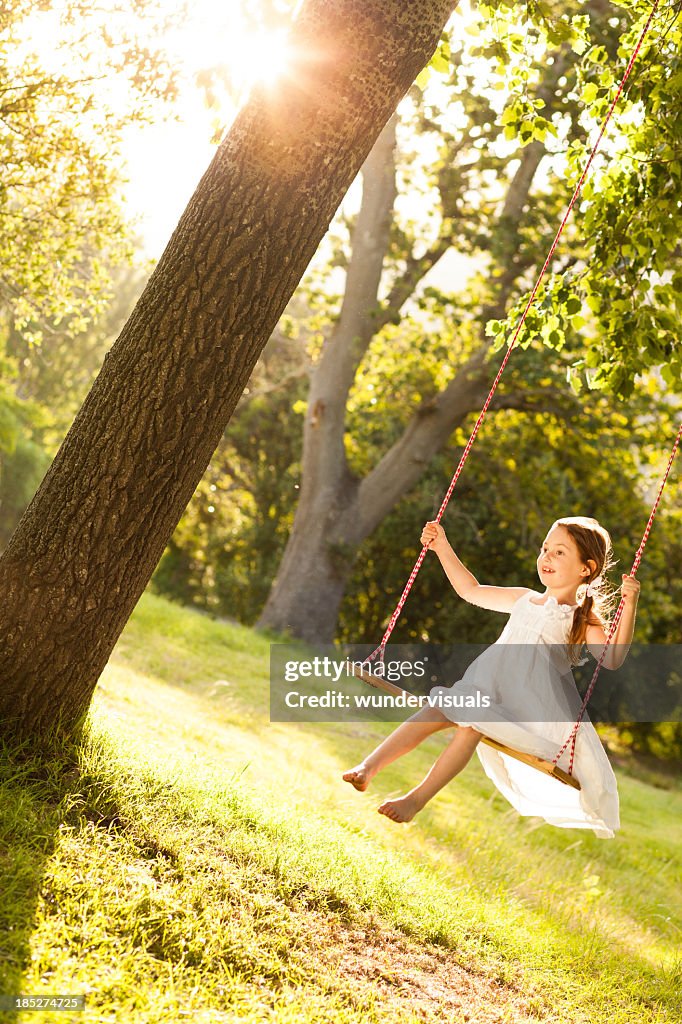 Girl Swinging In Park