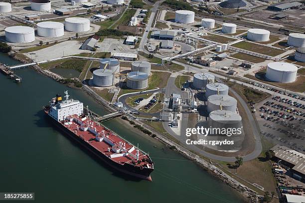 aerial view of crude oil tanker and storage tanks - gulf coast stockfoto's en -beelden
