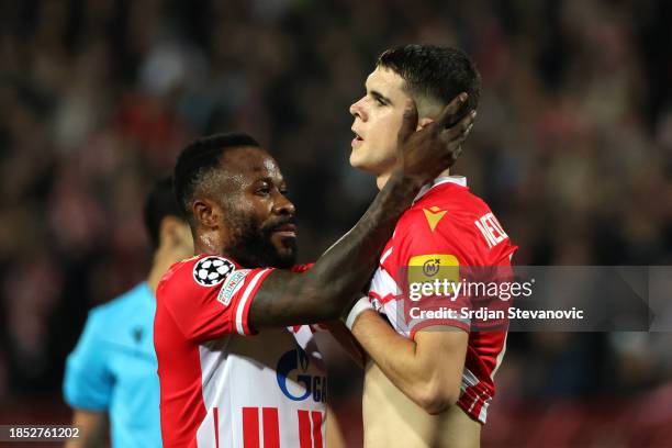 Guelor Kanga of FK Crvena zvezda interacts with teammate Kosta Nedeljkovic during the UEFA Champions League match between FK Crvena zvezda and...