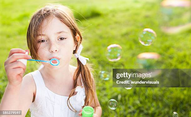 girl blowing bubbles - bubble ponytail stock pictures, royalty-free photos & images