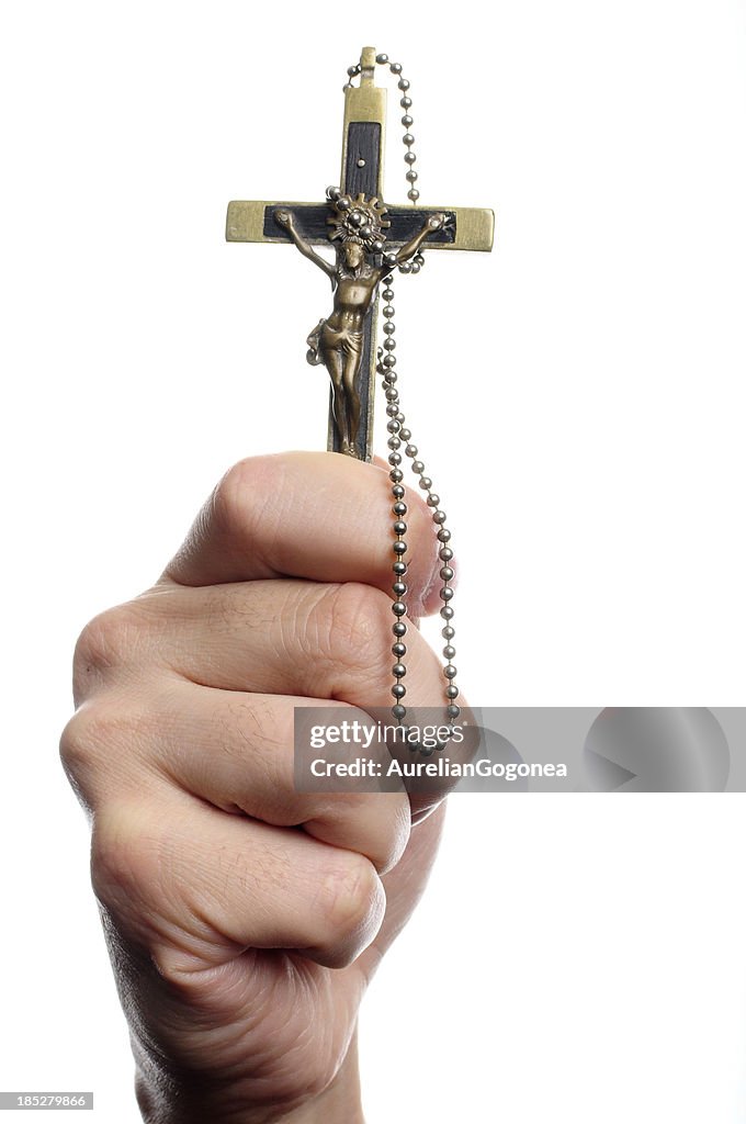 Adult man hand holding a christian cross