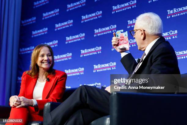 David Rubenstein, the President of The Economic Club, holds up a Barbie car toy during an interview with Mary Barra, CEO of General Motors, at the...