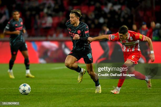 Kosta Nedeljkovic of FK Crvena Zvezda and Jack Grealish of Manchester City battle for the ball during the UEFA Champions League match between FK...