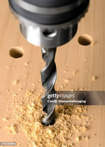 drill press and twist bit boring into wood - drill bit stockfoto's en -beelden