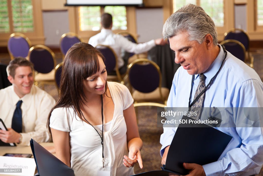 Conference attendees discussing event schedule