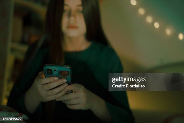 portrait of a person with mobile phone in hand - cyberbullying stock pictures, royalty-free photos & images