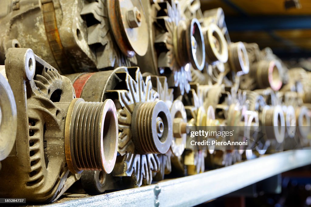 Random parts of used cars sitting in junkyard warehouse