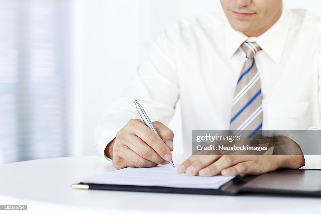 Businessman Writing On a Document