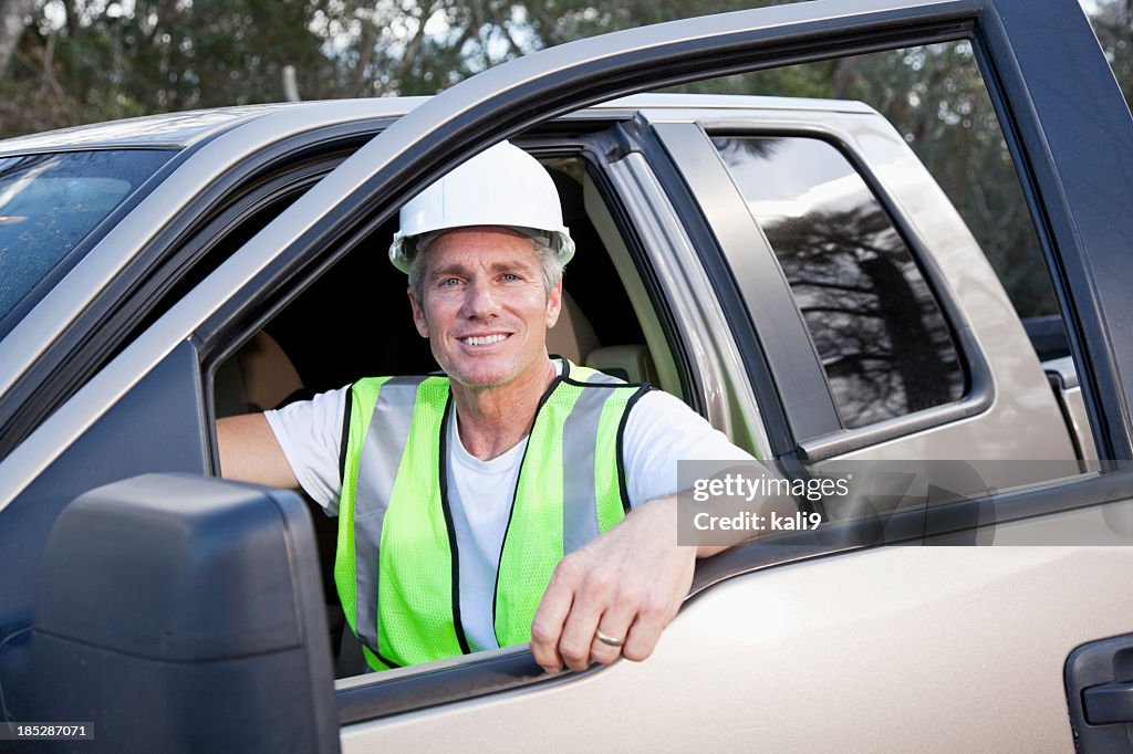 Manual worker wearing hardhat and safety vest