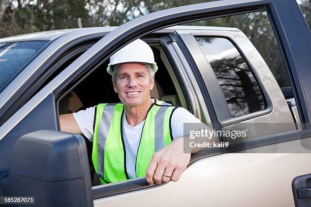 manual worker wearing hardhat and safety vest - reflexkläder bildbanksfoton och bilder