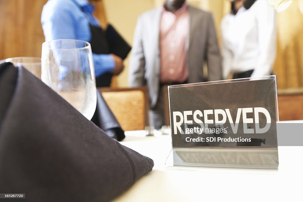 Reserved Def Reserved Sign Closeup While Guests Are Being Directed To Table High-Res ...