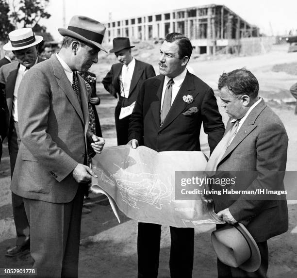 American urban planner Robert Moses shows the blueprints of Flushing Meadows to Chairman of the Mayor's Committee on Receptions to Distinguished...