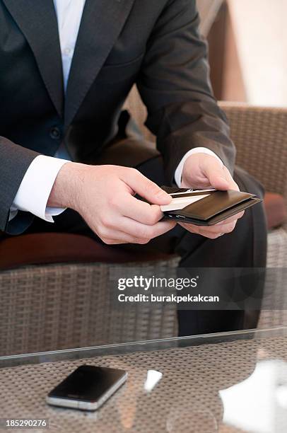 businessman takes his credit card from the purse - paid absence stock pictures, royalty-free photos & images