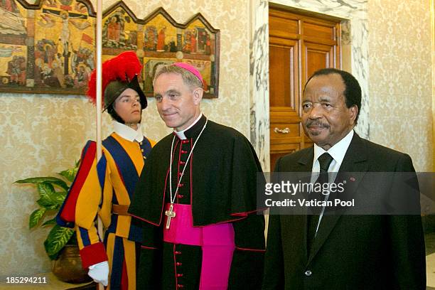Cameroon President Paul Biya , flanked by Prefect of the Pontifical House and former personal secretary of Pope Benedict XVI Georg Ganswein , arrives...