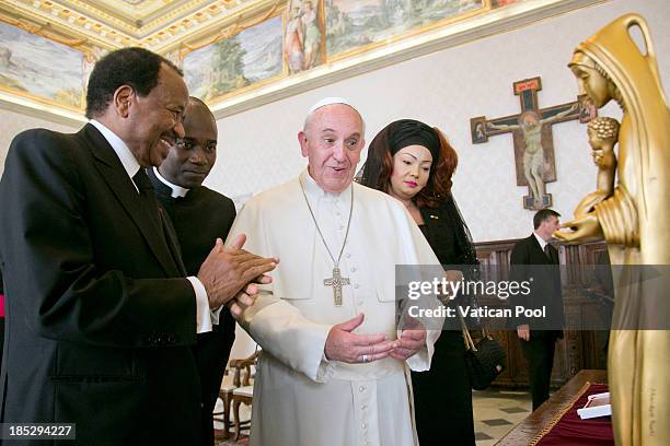 Pope Francis exchanges gifts with Cameroon President Paul Biya and his wife Chantal Biya during an audience at Vatican Apostolic Palace on October...