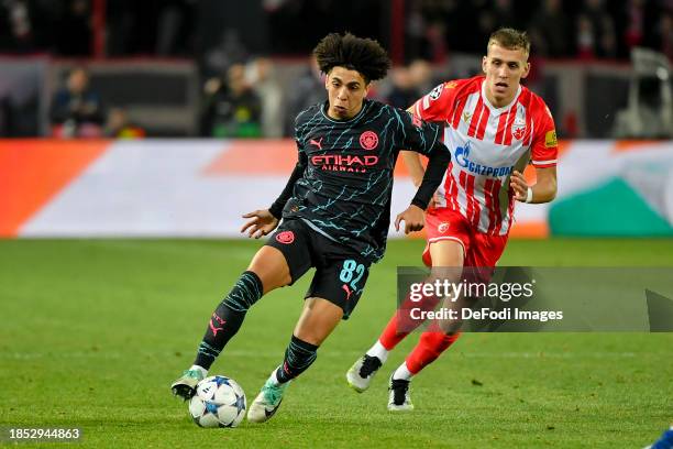 Rico Lewis of Manchester City and Kosta Nedeljkovic of FK Crvena Zvezda battle for the ball during the UEFA Champions League match between FK Crvena...