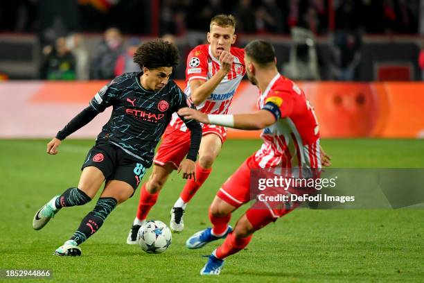 Rico Lewis of Manchester City and Kosta Nedeljkovic of FK Crvena Zvezda battle for the ball during the UEFA Champions League match between FK Crvena...
