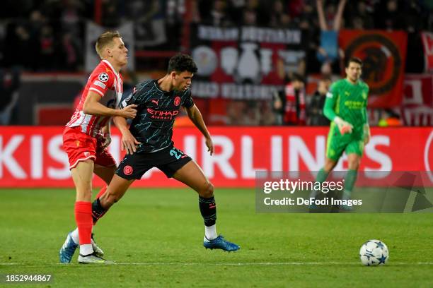 Kosta Nedeljkovic of FK Crvena Zvezda and Matheus Nunes of Manchester City battle for the ball during the UEFA Champions League match between FK...