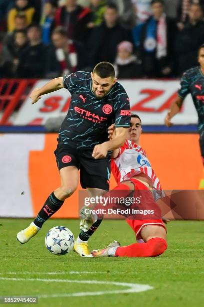 Mateo Kovacic of Manchester City and Kosta Nedeljkovic of FK Crvena Zvezda battle for the ball during the UEFA Champions League match between FK...