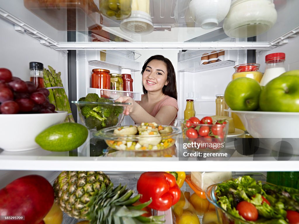 Taking healthy food from fridge