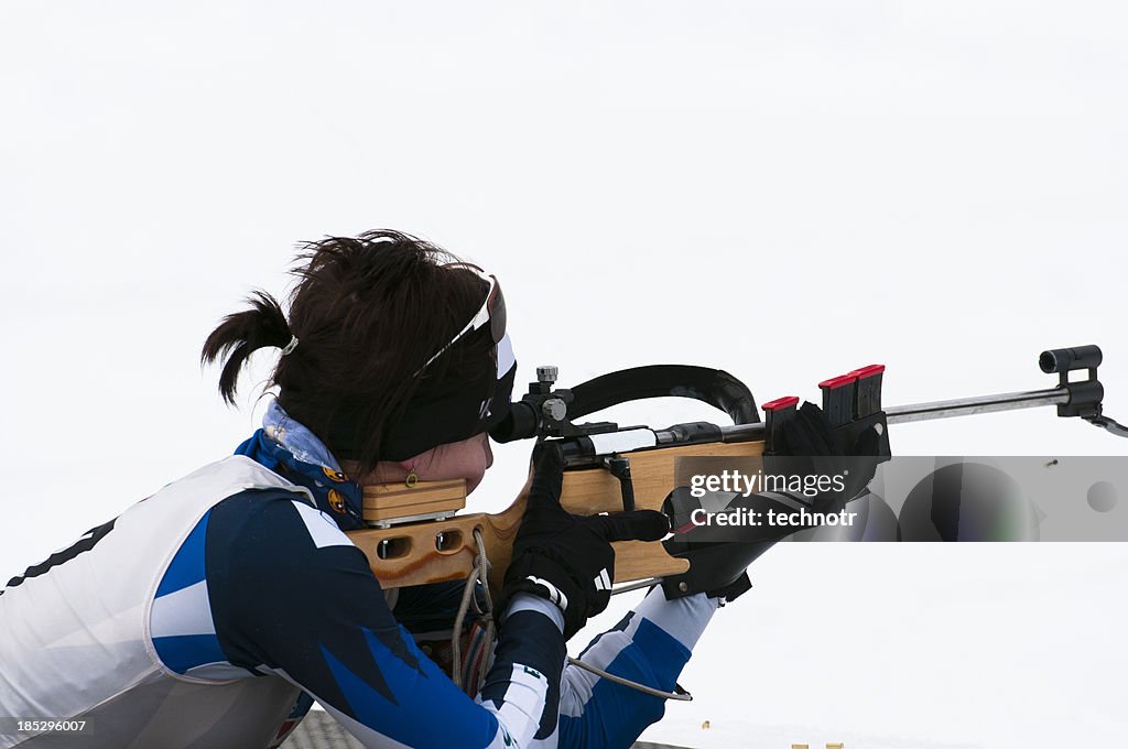 Young women shooting at biathlon competition