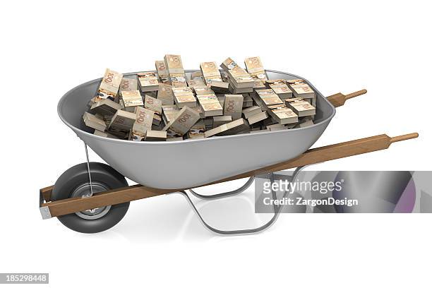 wheel barrow full of canadian money - cash wheelbarrow stock pictures, royalty-free photos & images