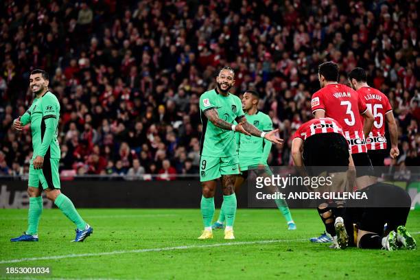 Atletico Madrid's Argentinian forward Angel Correa and Atletico Madrid's Dutch forward Memphis Depay react as Athletic Bilbao's Spanish goalkeeper...