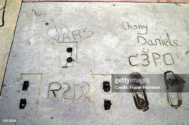 "Star Wars" robots R2D2, C-3PO and Anthony Daniels's prints are seen outside Grauman's Chinese Theatre on March 16, 2003 in Hollywood, California.