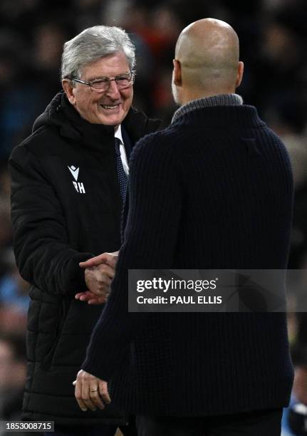 Crystal Palace's English manager Roy Hodgson reacts as he shakes hands with Manchester City's Spanish manager Pep Guardiola following the English...