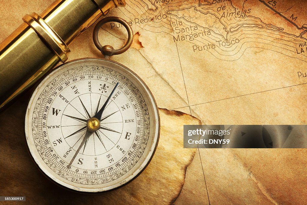 Compass And Spyglass On A Map
