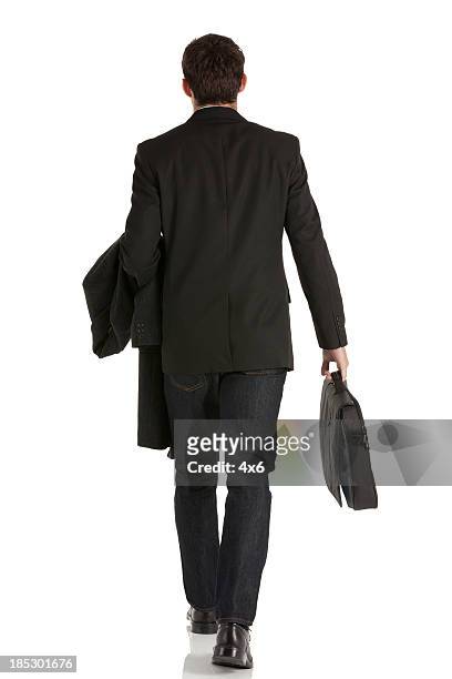 rear view of a businessman walking - overcoat stock pictures, royalty-free photos & images