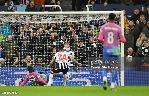 Fikayo Tomori of AC Milan clears off the line whilst under pressure from Miguel Almiron of Newcastle United during the UEFA Champions League match...