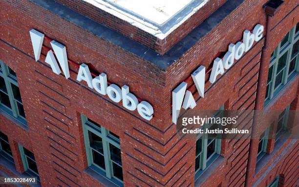 Sign is displayed on the exterior of an Adobe office on December 13, 2023 in San Francisco, California. Computer software company Adobe will report...