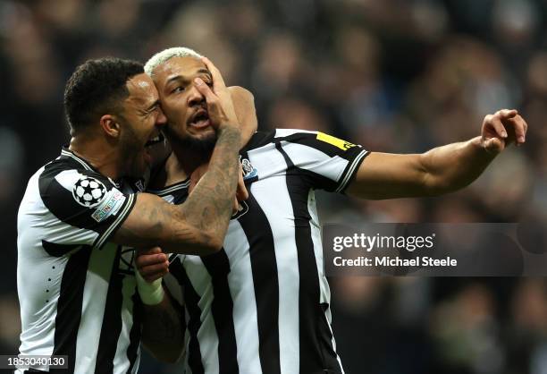 Joelinton of Newcastle United celebrates with teammate Callum Wilson after scoring their team's first goal during the UEFA Champions League match...