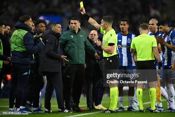 Referee, Istvan Kovacs shows a yellow card to Sergio Conceicao, Head Coach of FC Porto, during the UEFA Champions League match between FC Porto and...
