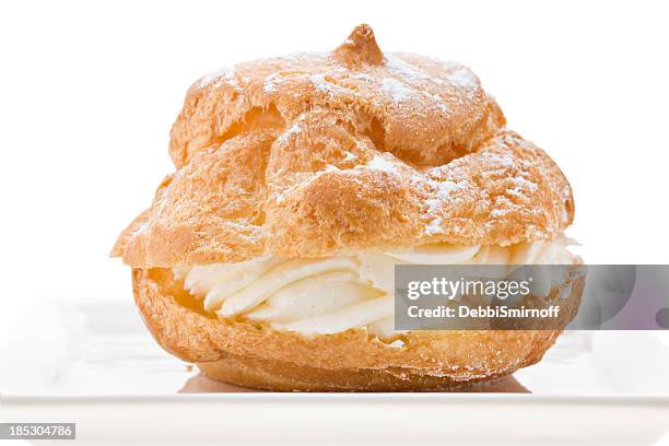 cream puff on a white plate - pastry dough stock pictures, royalty-free photos & images