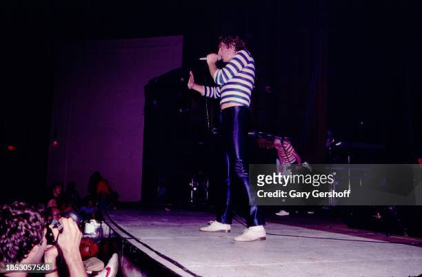 English Rock singer Joe Elliott, of the group Def Leppard, performs onstage at the Palladium, New York, New York, August 1, 1980. Visible in the...