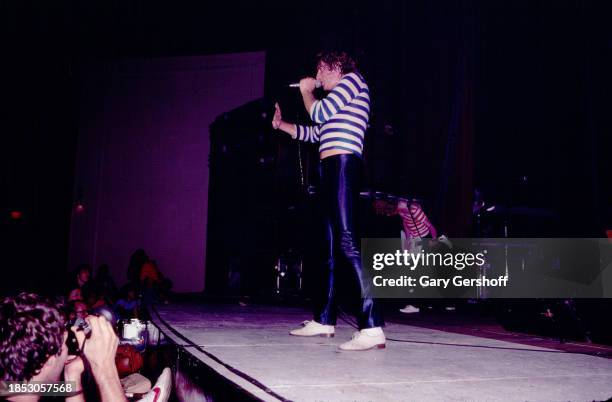 English Rock singer Joe Elliott, of the group Def Leppard, performs onstage at the Palladium, New York, New York, August 1, 1980. Visible in the...